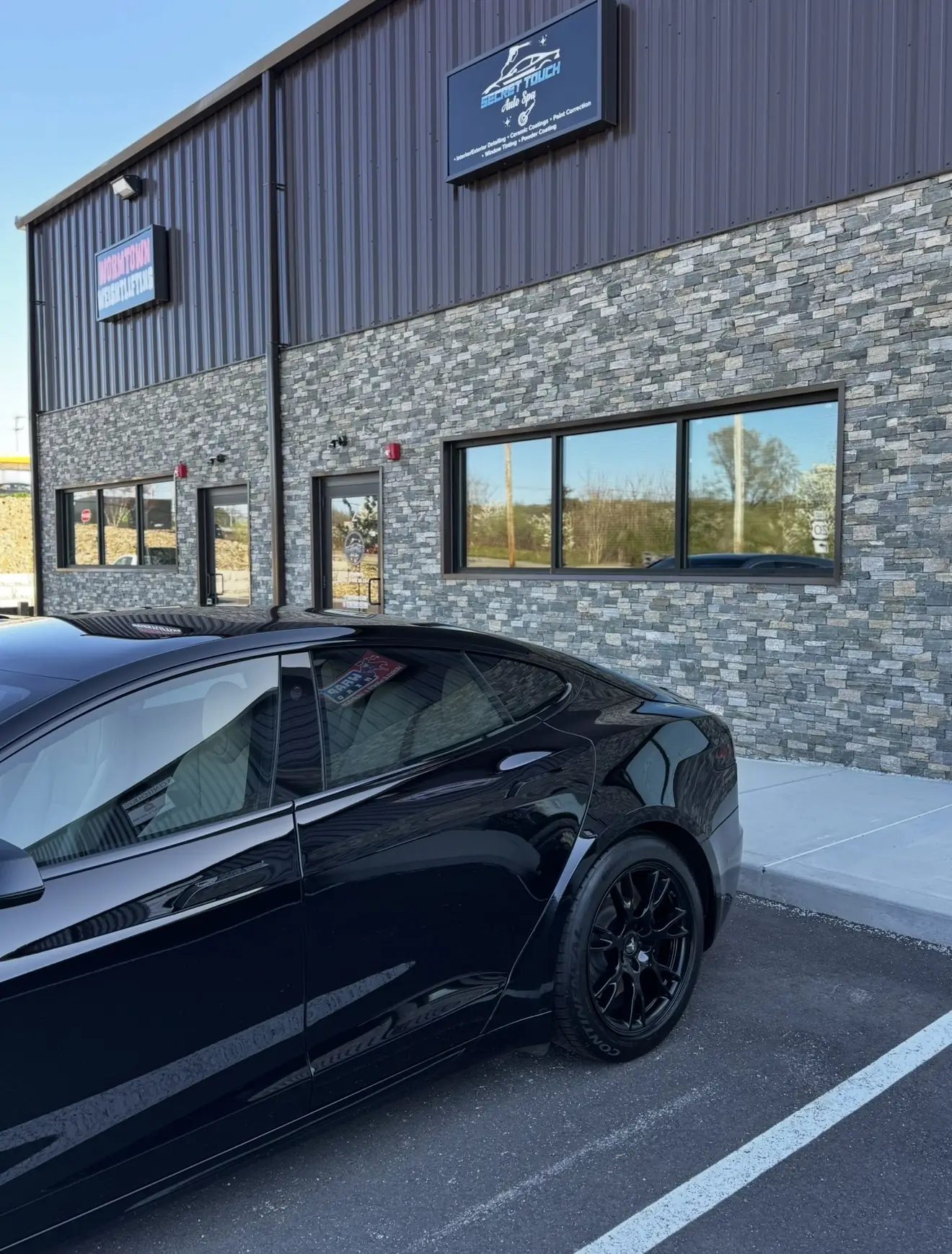 Black Tesla Model S Plaid after paint correction and ceramic coating outside in natural light at Secret Touch Auto Spa Shrewsbury MA