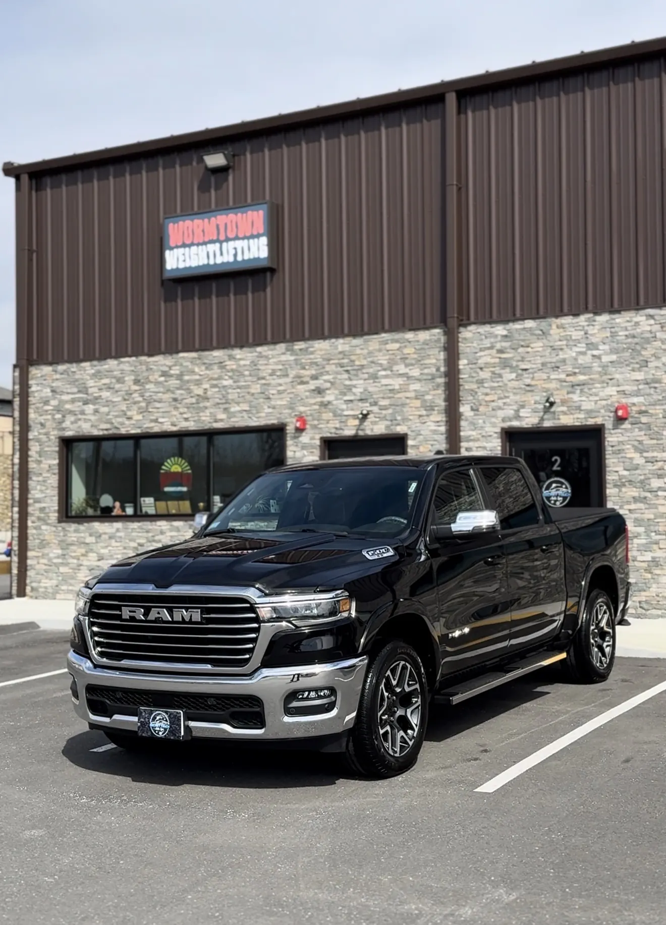 Black Ram 1500 Laramie after paint correction and ceramic coating outside in natural light at Secret Touch Auto Spa Shrewsbury MA