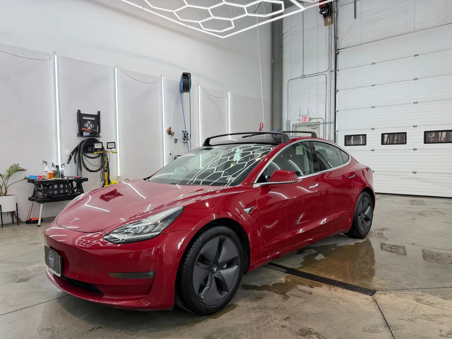 Red Tesla Model 3 with paint protection film at Secret Touch Auto Spa Shrewsbury MA