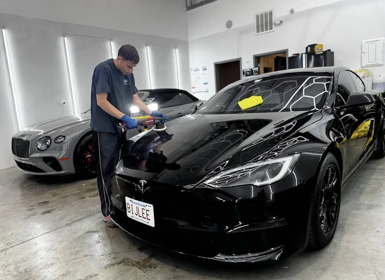 Machine paint correction in progress on a vehicle at Secret Touch Auto Spa Shrewsbury MA